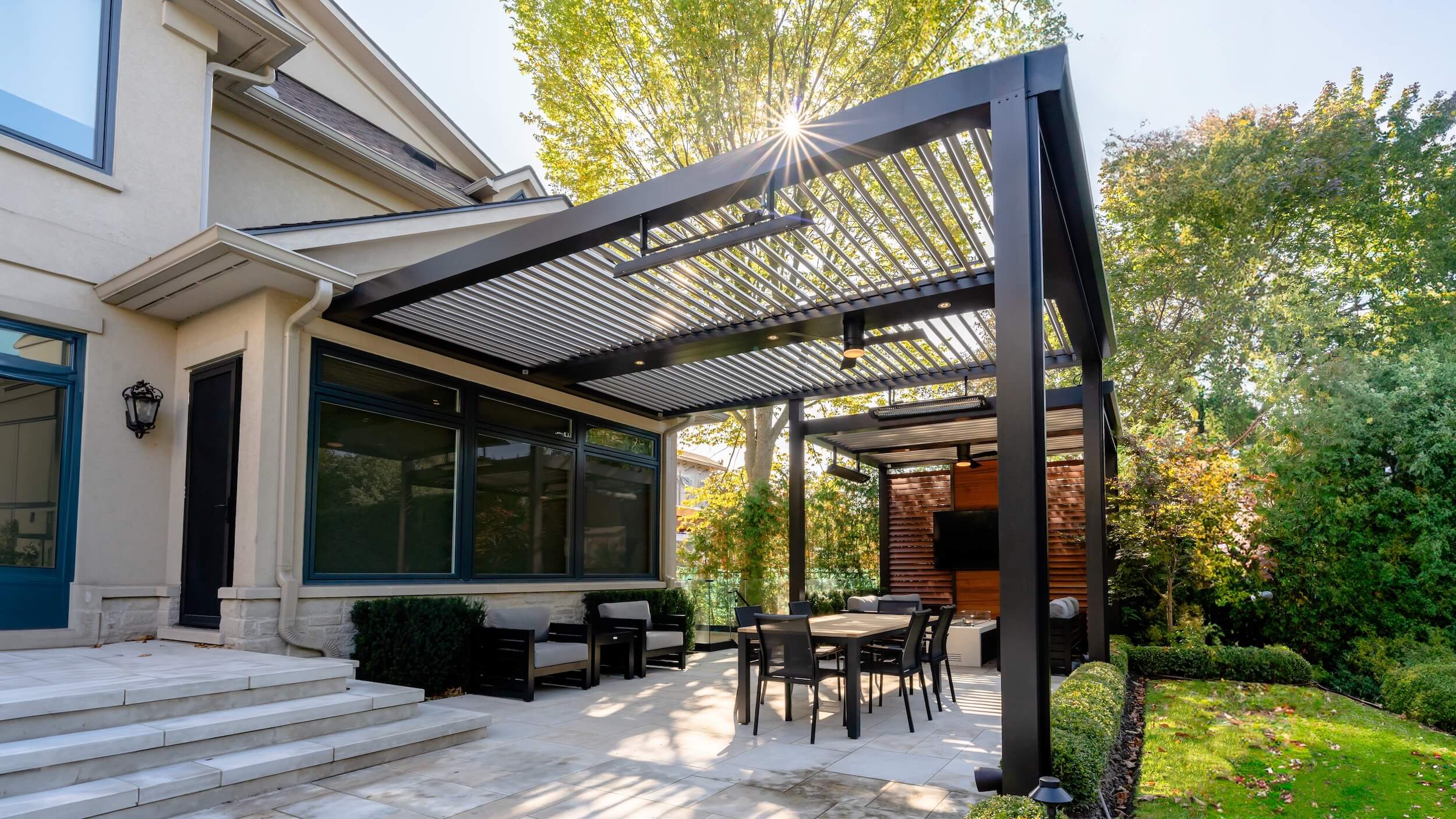 StruXure Pergola X installation in a luxury backyard with custom lighting and fan
